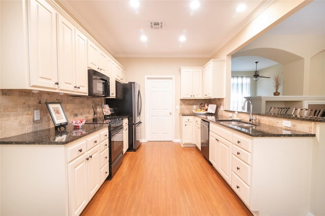 kitchen with white cabinetry, black appliances, dark stone countertops, and ceiling fan