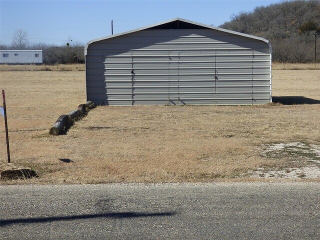 view of side of property featuring a storage shed