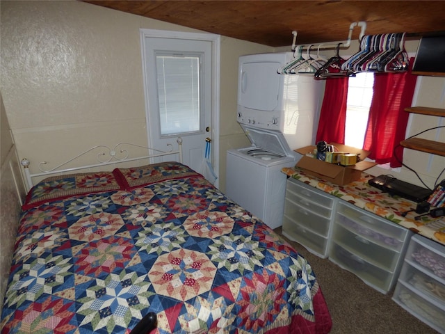 bedroom featuring stacked washer and dryer