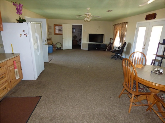 carpeted dining area featuring ceiling fan, french doors, and visible vents