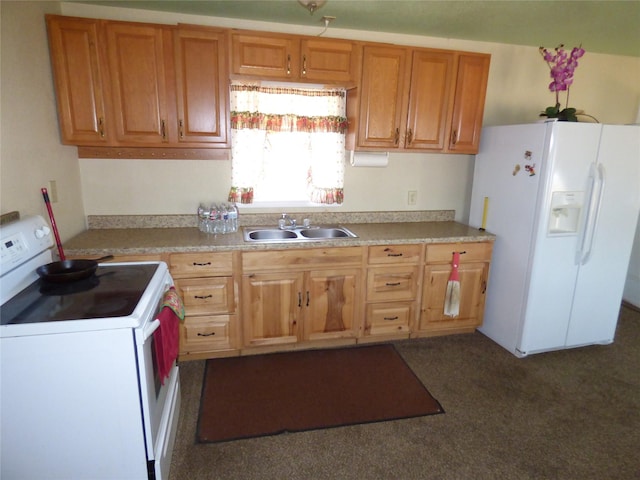 kitchen with light countertops, white appliances, and a sink