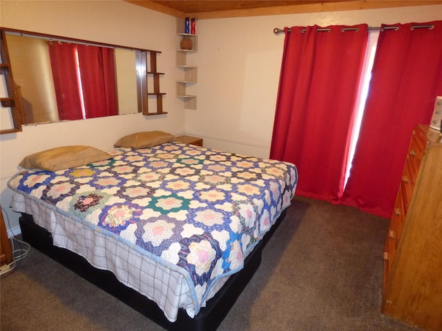 bedroom featuring dark carpet