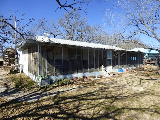 view of outbuilding with a sunroom