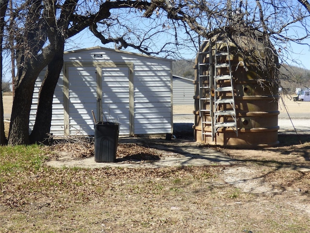 view of home's exterior with a shed and an outdoor structure