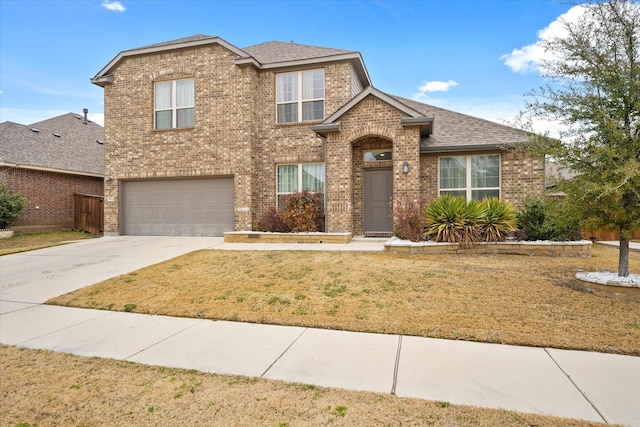 front of property with a garage and a front lawn