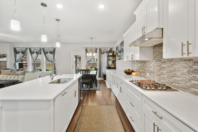 kitchen with sink, white cabinetry, hanging light fixtures, an island with sink, and stainless steel appliances