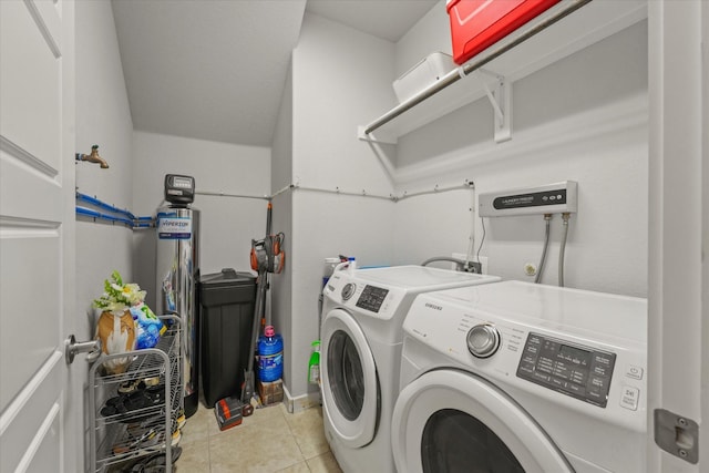 washroom with light tile patterned floors and washer and clothes dryer