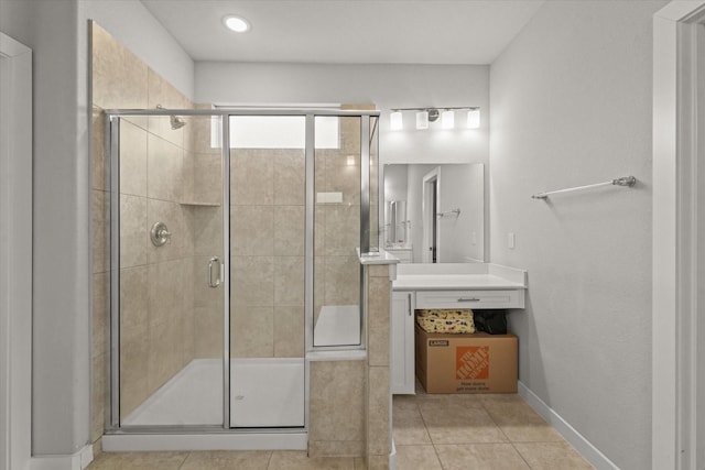 bathroom with walk in shower, tile patterned floors, and vanity