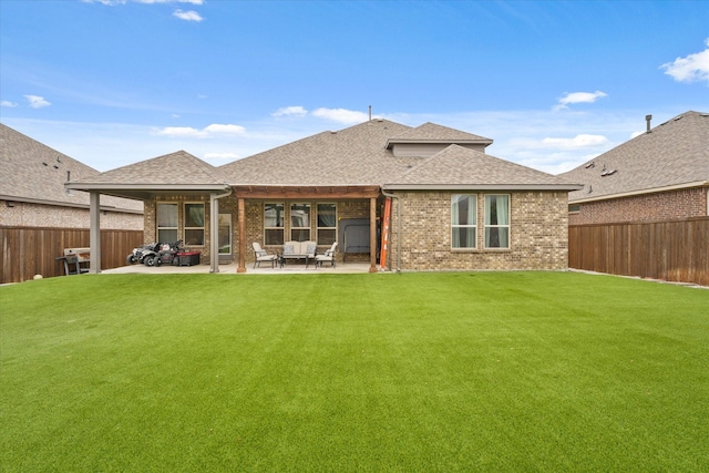 back of house with a yard and a patio area