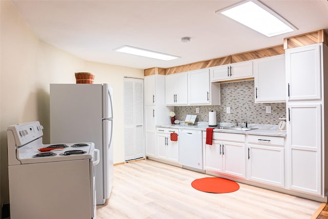 kitchen featuring backsplash, white appliances, sink, and white cabinets