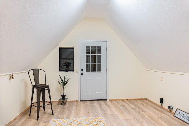 bonus room with vaulted ceiling and light hardwood / wood-style flooring