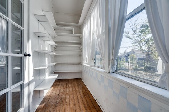 walk in closet with dark wood-type flooring