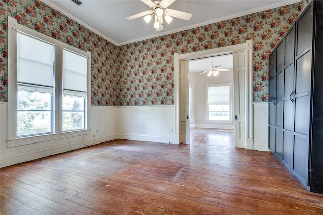 unfurnished room featuring ceiling fan, ornamental molding, and wood-type flooring