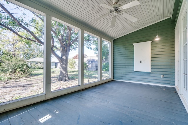 unfurnished sunroom featuring ceiling fan and vaulted ceiling