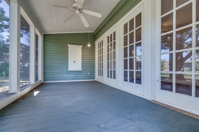 unfurnished sunroom with lofted ceiling and ceiling fan