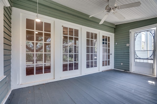 unfurnished sunroom with ceiling fan