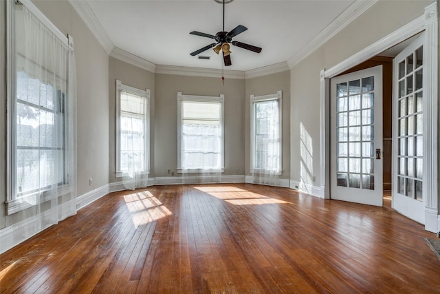 spare room with wood-type flooring, ornamental molding, and ceiling fan