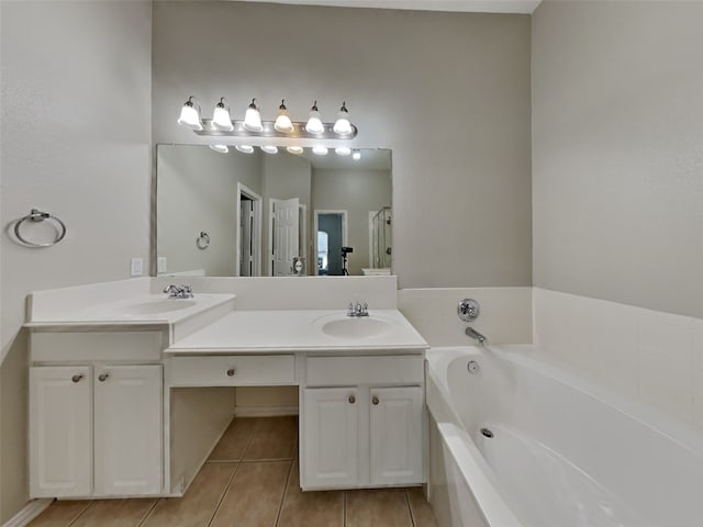 bathroom featuring tile patterned floors, a tub to relax in, and vanity