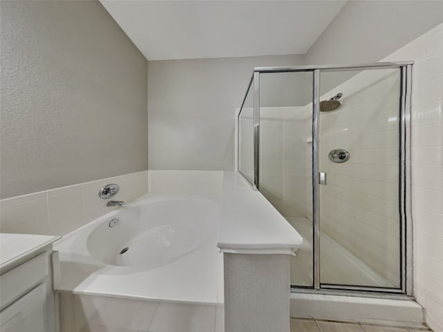 bathroom featuring vanity and separate shower and tub