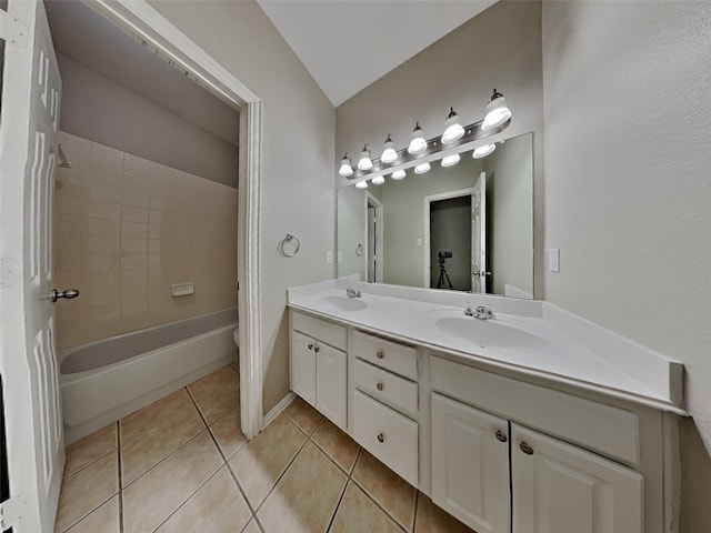 bathroom featuring tile patterned flooring, vanity, and tiled shower / bath