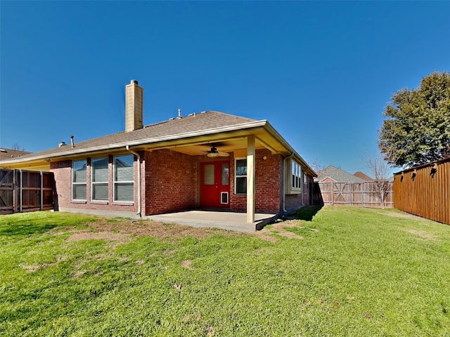 rear view of house featuring a yard, a patio area, and ceiling fan