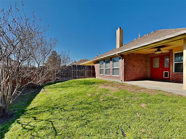 view of yard with ceiling fan and a patio