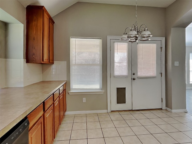 kitchen featuring decorative light fixtures, a chandelier, vaulted ceiling, stainless steel dishwasher, and backsplash