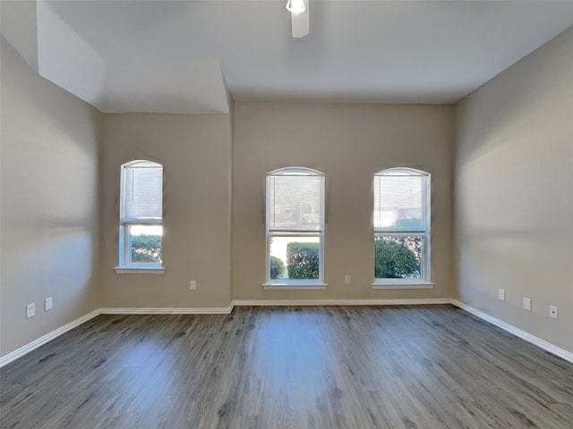 unfurnished room with hardwood / wood-style flooring and ceiling fan