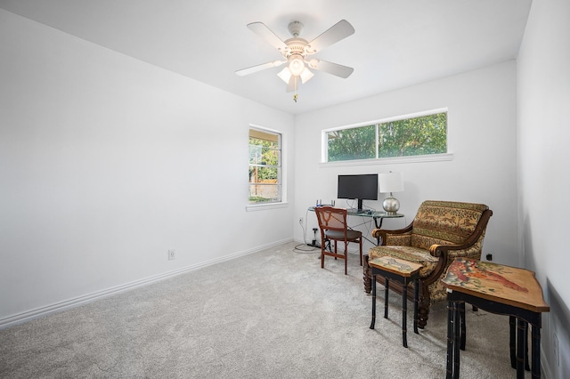 living area with carpet floors and ceiling fan