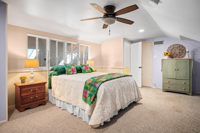 carpeted bedroom with ceiling fan and vaulted ceiling