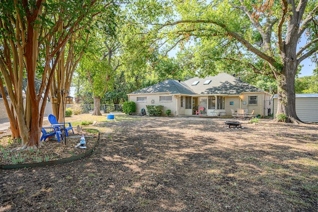 back of house featuring a fire pit