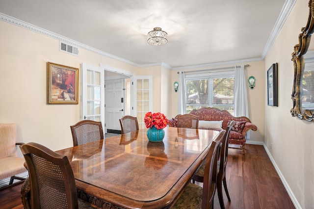 dining area with ornamental molding and dark wood-type flooring