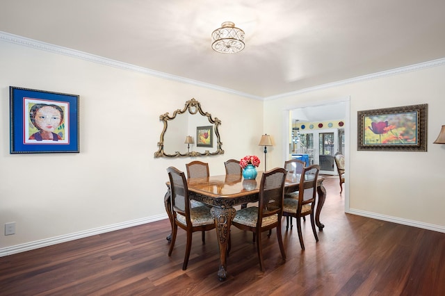 dining area with ornamental molding and dark hardwood / wood-style floors