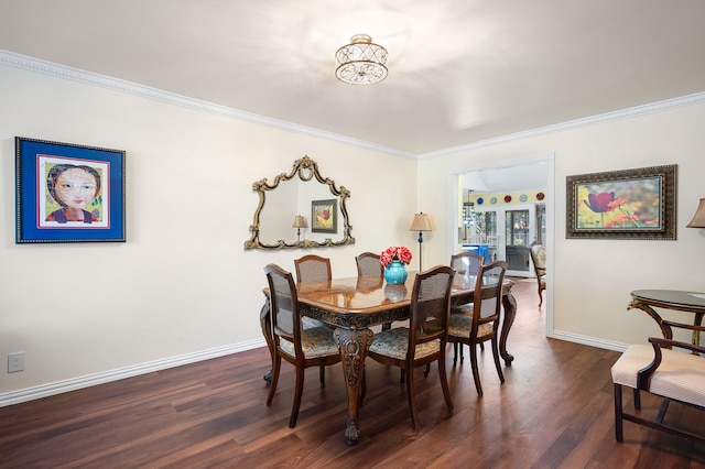 dining room with crown molding and dark hardwood / wood-style floors