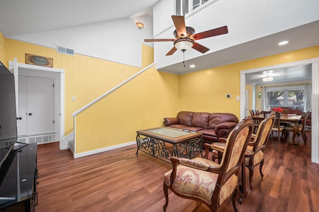 living room featuring vaulted ceiling, ceiling fan, and dark hardwood / wood-style flooring