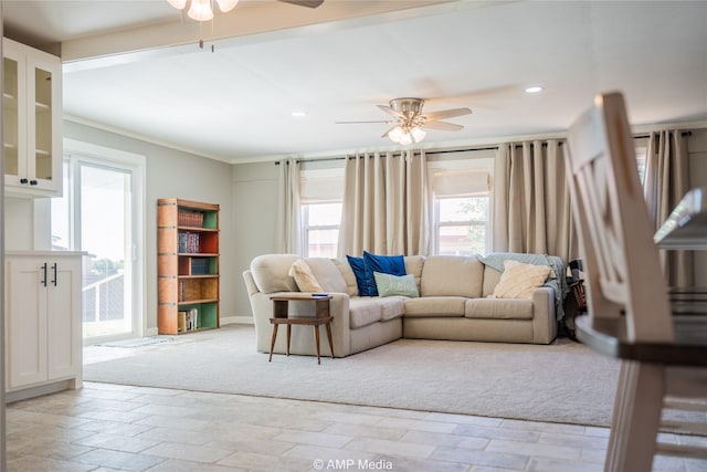 living room with crown molding and ceiling fan