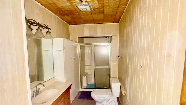 bathroom with an enclosed shower, vanity, and toilet