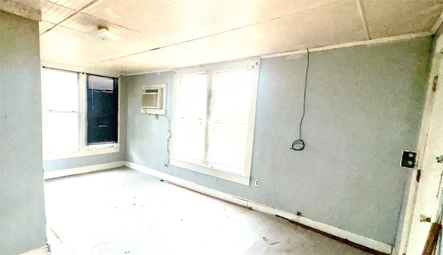 spare room with an AC wall unit