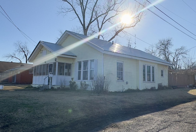 view of side of home with a sunroom