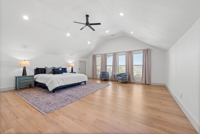 bedroom featuring light hardwood / wood-style flooring, ceiling fan, and vaulted ceiling