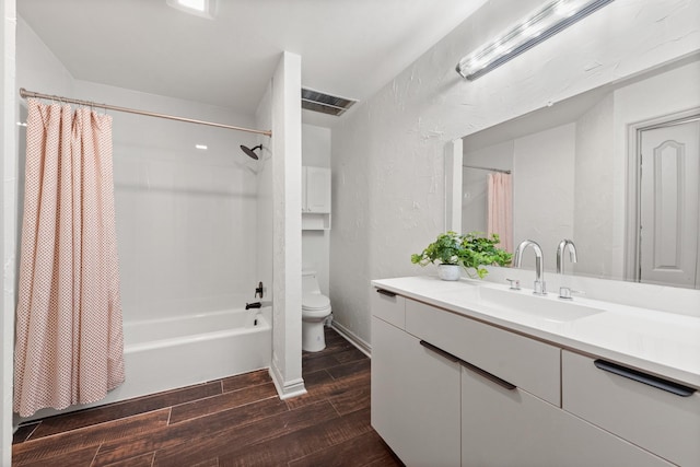 full bathroom featuring vanity, shower / tub combo, and toilet