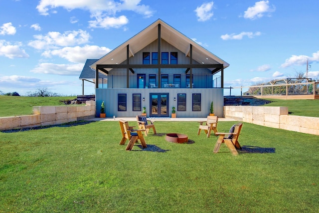 back of property featuring a balcony and a lawn