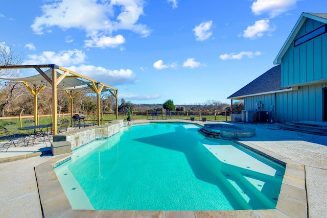 view of swimming pool featuring a patio and an in ground hot tub