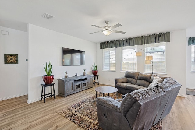 living room featuring ceiling fan and light hardwood / wood-style floors