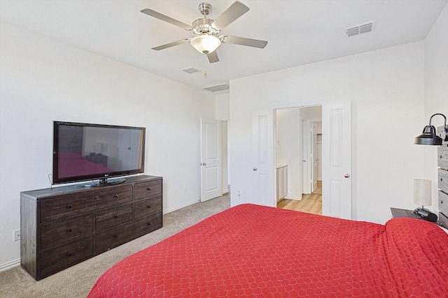 bedroom with ceiling fan and light carpet