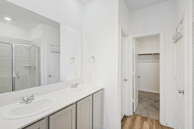 bathroom featuring vanity, hardwood / wood-style flooring, and walk in shower