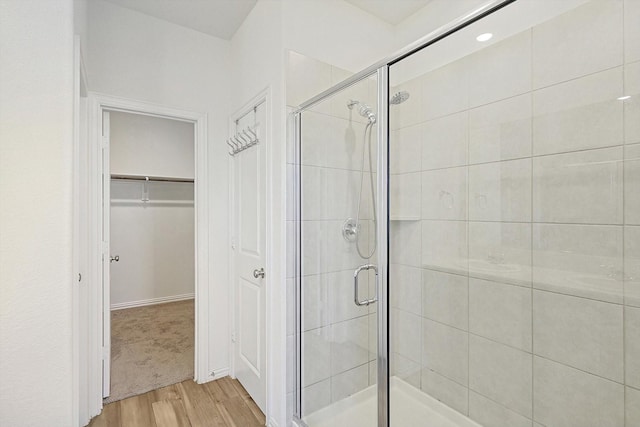 bathroom featuring hardwood / wood-style floors and a shower with shower door