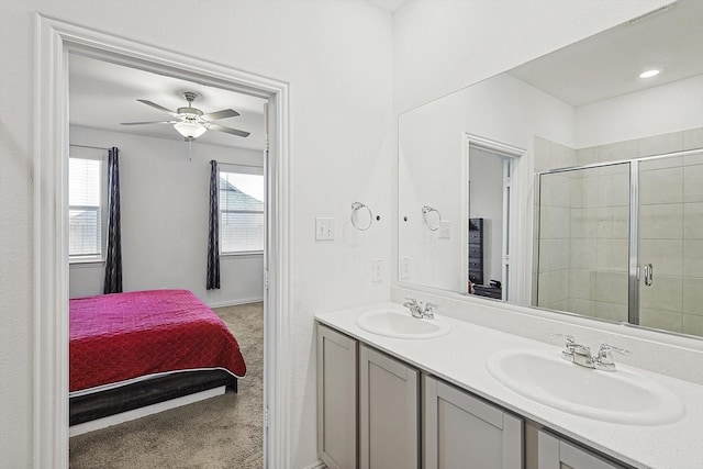 bathroom featuring vanity, ceiling fan, and walk in shower