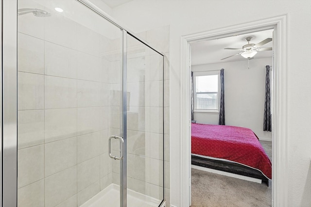 bathroom featuring ceiling fan and a shower with shower door