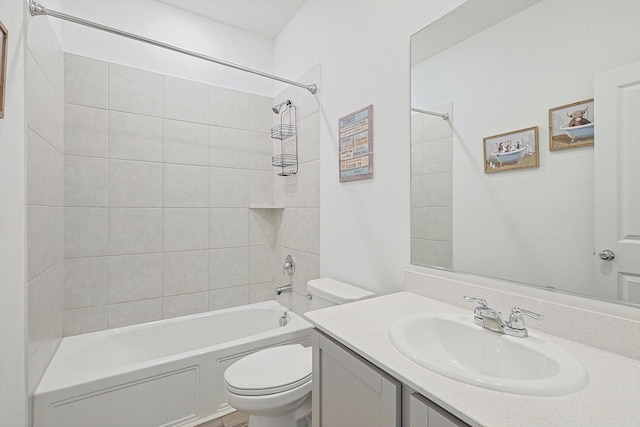 full bathroom with vanity, tiled shower / bath, and toilet